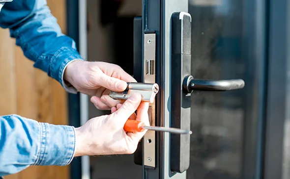 Hand turning a door knob, showcasing professional home lock installation services in Weddingon, NC.