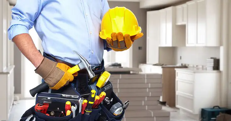 The professional handyman is standing in kitchen in Weddington, NC.