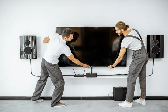 Two professional worker mounting tv in Weddington, NC.