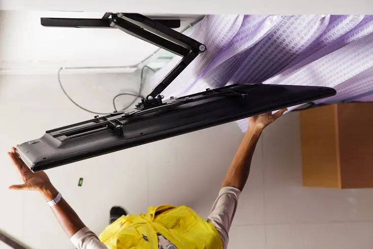 The worker is mounting the tv in Waxhaw, NC.