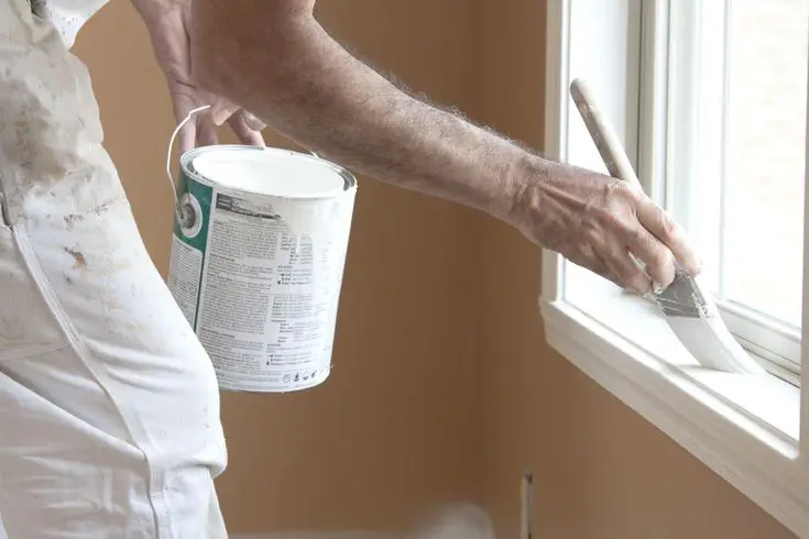 A professional painter is painting the window in Charlotte, NC.