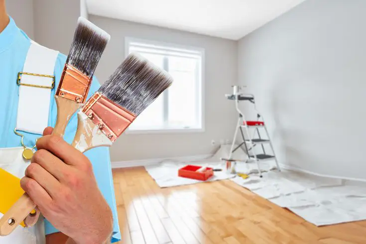 The worker is standing in the room after completion of the painting in Weddington, NC.